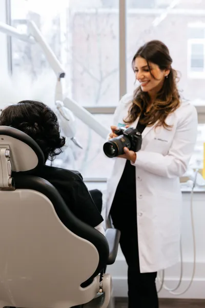 Dr. Mikhaylova reviewing smile photos with a patient at Thrive Dental